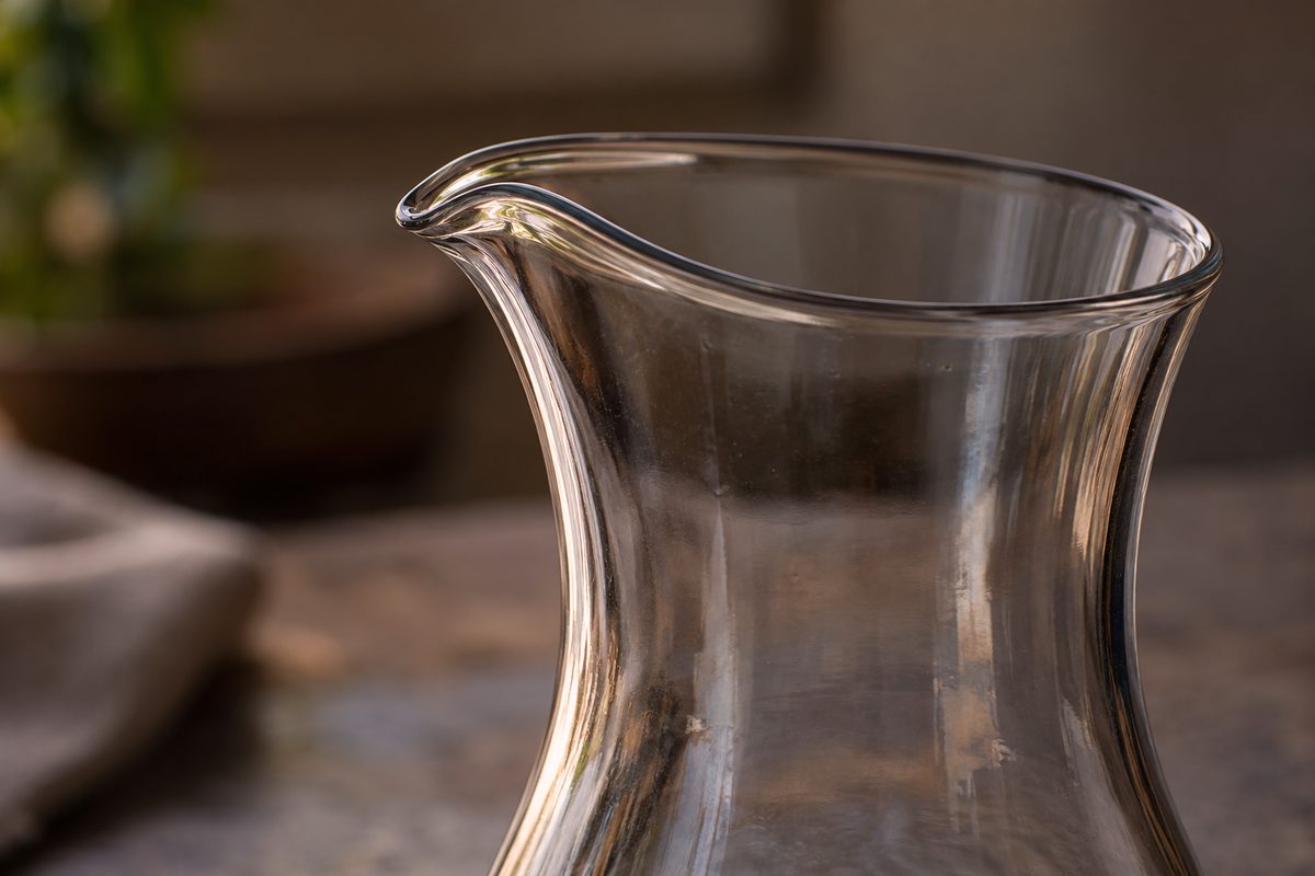 Fire-polished drip-free pouring lip contour on a restaurant table carafe.